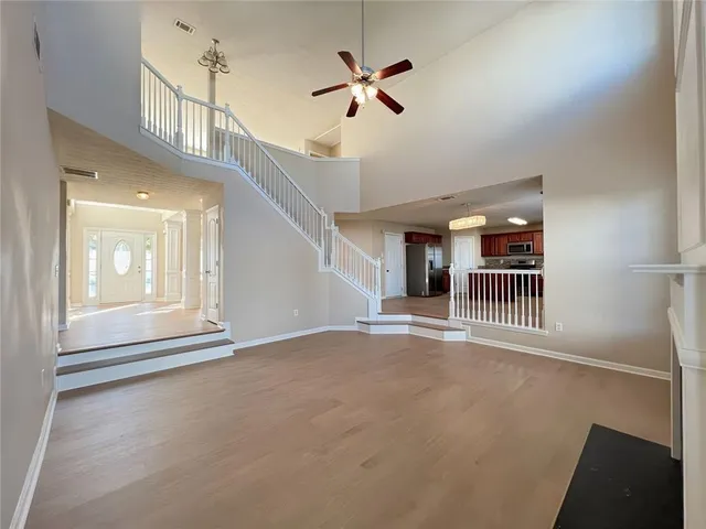 a view of entryway and hall with wooden floor