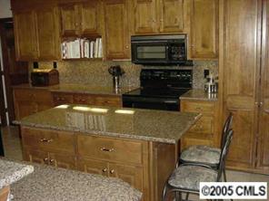 12 Pine Point Road Lake Wylie, SC 29710 - Photo 8 of 8 a kitchen with granite countertop a stove top oven microwave and cabinets