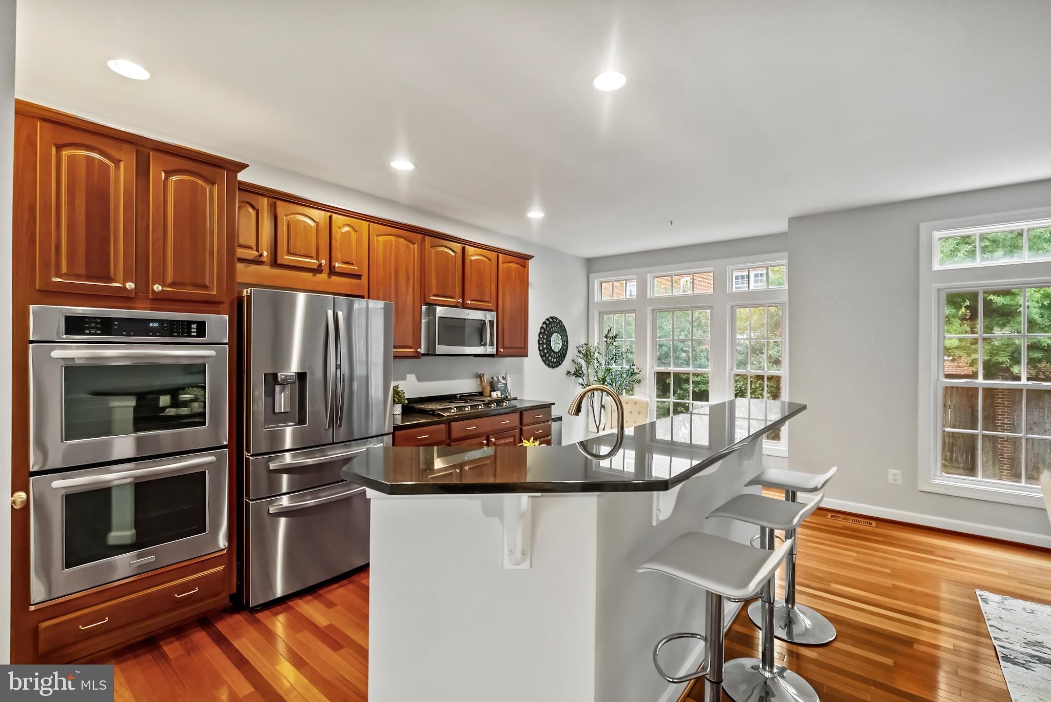 904 West Glebe Road Alexandria, VA 22305 - Photo 11 of 38 a kitchen with stainless steel appliances granite countertop a refrigerator stove and sink