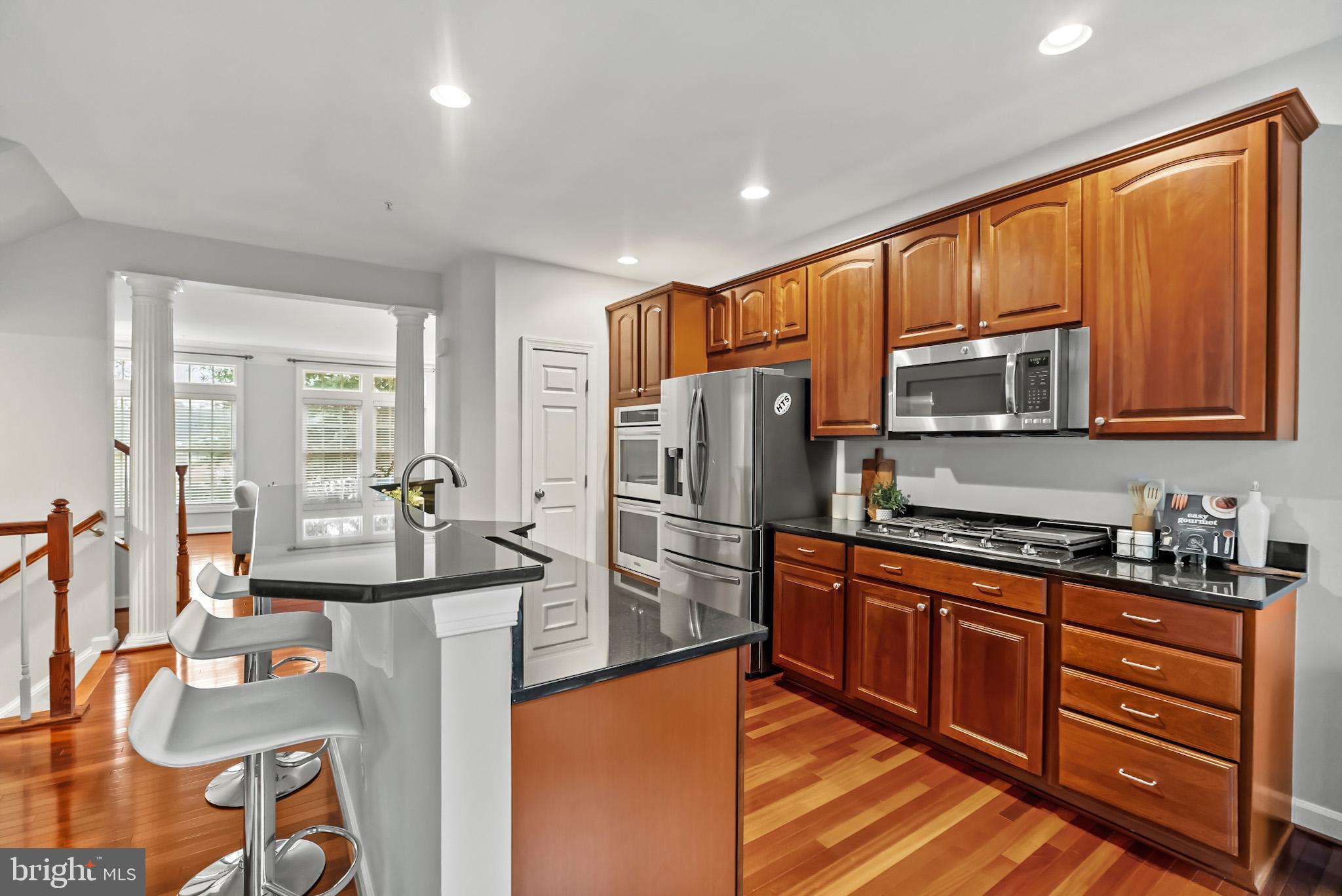 904 West Glebe Road Alexandria, VA 22305 - Photo 12 of 38 a kitchen with stainless steel appliances granite countertop a refrigerator stove microwave and sink