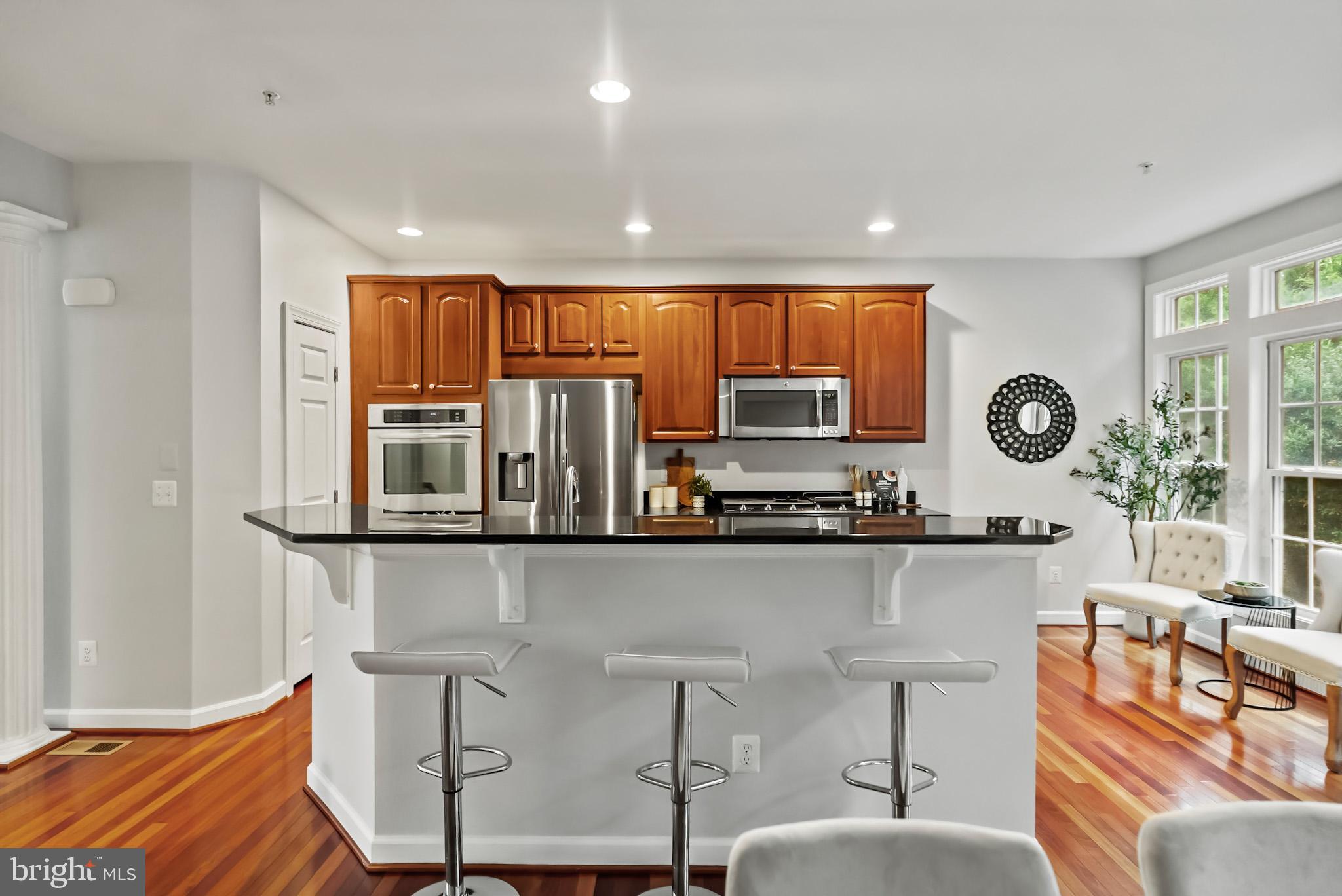 904 West Glebe Road Alexandria, VA 22305 - Photo 10 of 38 a kitchen with stainless steel appliances granite countertop a stove a sink and a refrigerator