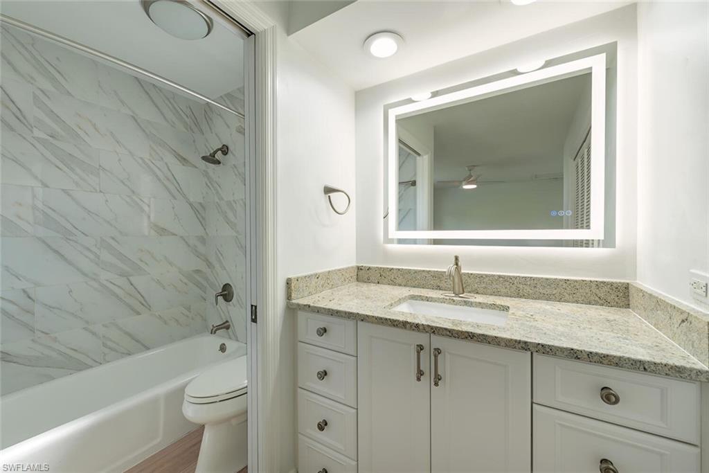 185 4th Street South Naples, FL 34102 - Photo 14 of 22 a bathroom with a granite countertop sink toilet and shower