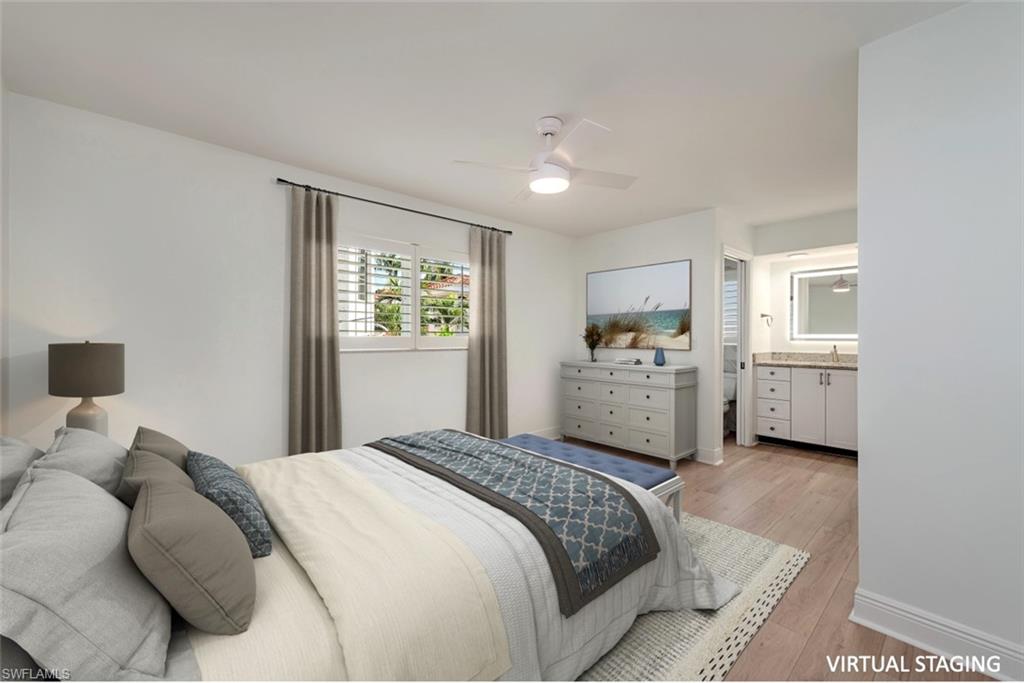 185 4th Street South Naples, FL 34102 - Photo 15 of 22 a spacious bedroom with a large bed and a view of kitchen