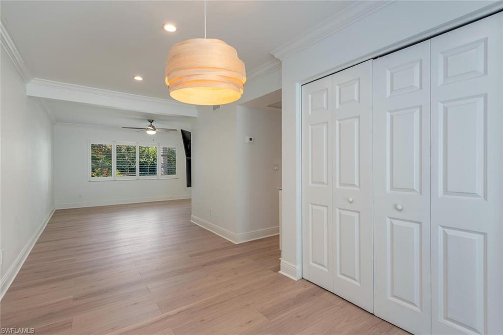 185 4th Street South Naples, FL 34102 - Photo 18 of 22 an empty room with wooden floor and windows