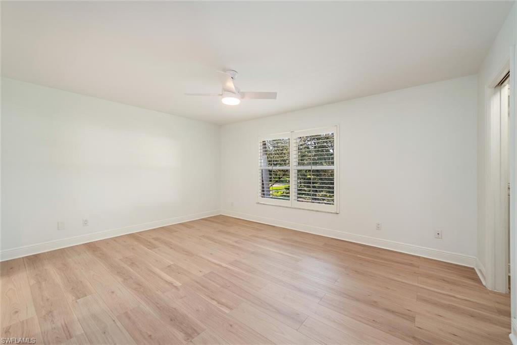 185 4th Street South Naples, FL 34102 - Photo 22 of 22 an empty room with wooden floor and windows