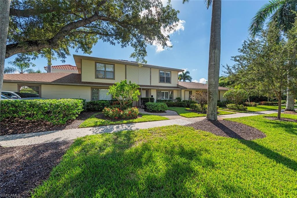 185 4th Street South Naples, FL 34102 - Photo 4 of 22 a view of a house with swimming pool and a yard