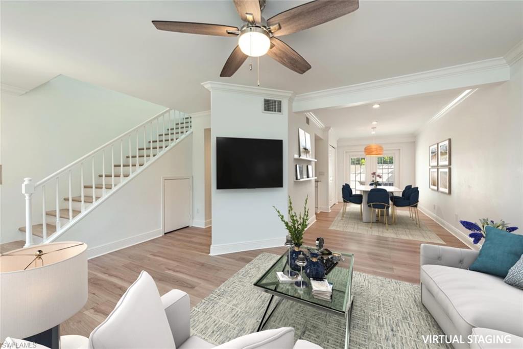 185 4th Street South Naples, FL 34102 - Photo 7 of 22 a living room with furniture and a flat screen tv with wooden floor