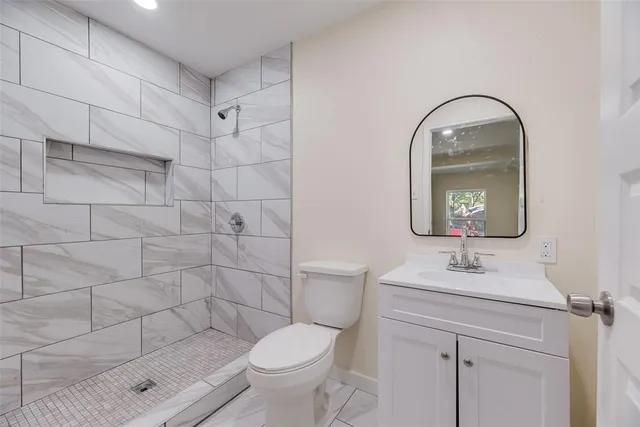 a bathroom with a sink toilet and shower