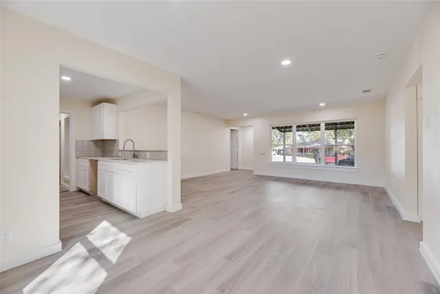 a view of a kitchen with wooden floor and electronic appliances