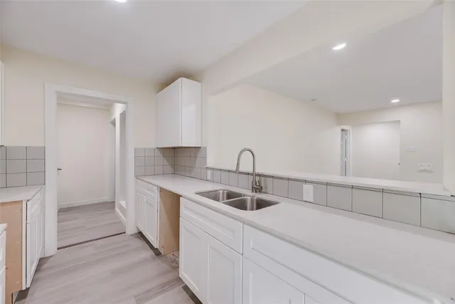 a kitchen with a sink and cabinets