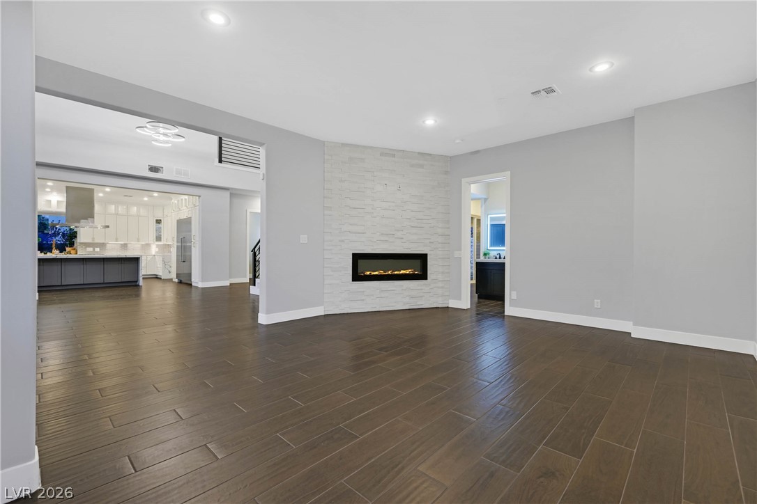 6 Rue Du Ville Henderson, NV 89011 - Photo 47 of 99 This expansive living area features elegant flooring and a modern fireplace, ideal for stylish living.