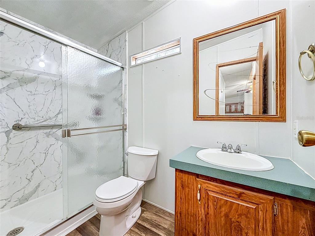 1819 Sinclair Hills Road Lutz, FL 33549 - Photo 42 of 60 a bathroom with a sink toilet and shower
