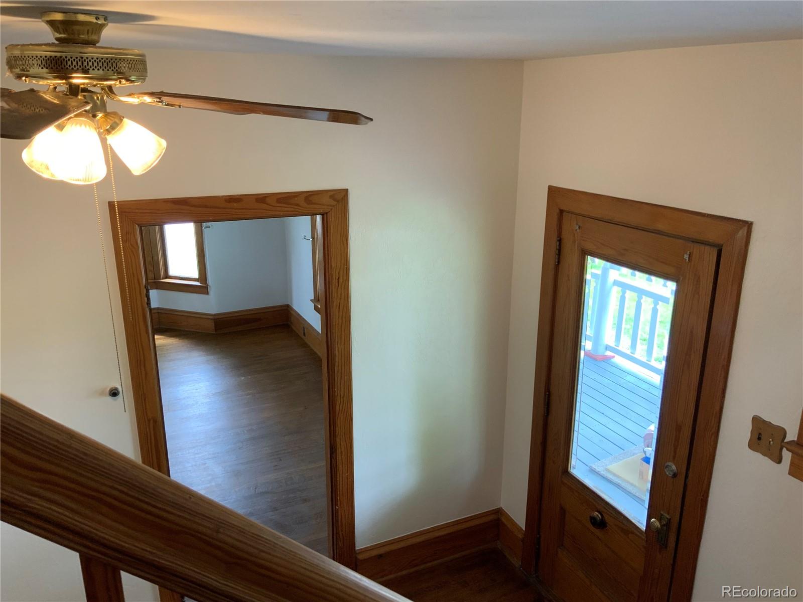 1011 Main Street Meeker, CO 81641 - Photo 24 of 28 a view of a hallway with wooden floor and a mirror