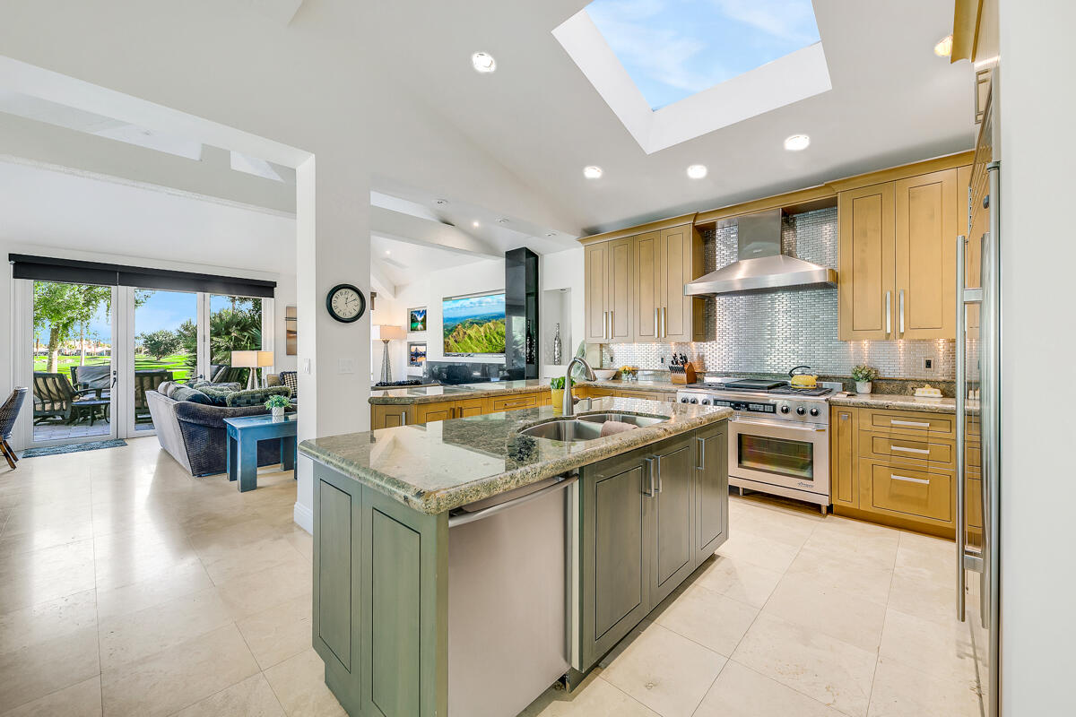 54310 Riviera La Quinta, CA 92253 - Photo 12 of 45 a kitchen with stainless steel appliances granite countertop sink stove and refrigerator