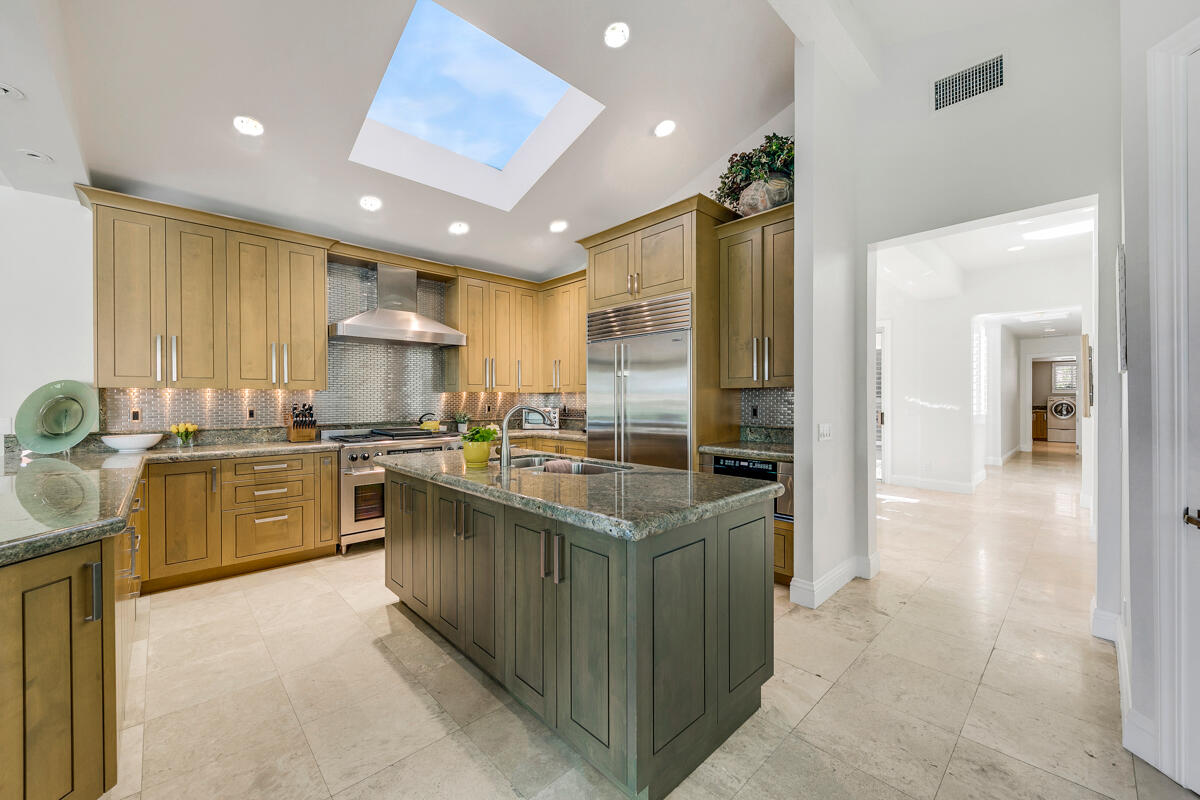 54310 Riviera La Quinta, CA 92253 - Photo 13 of 45 a kitchen with a sink stove cabinets and refrigerator