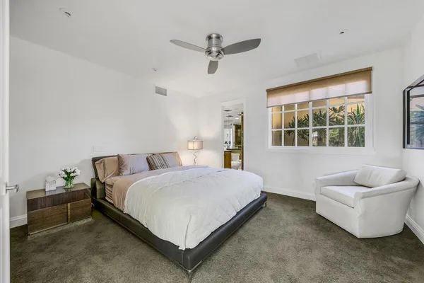 a bedroom with a bed and window