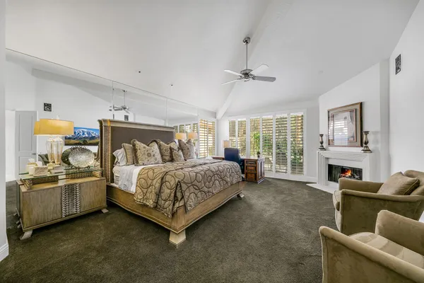 a bedroom with bed couch and window