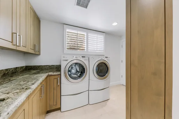 a view of a patio with table and chairs and potted plants