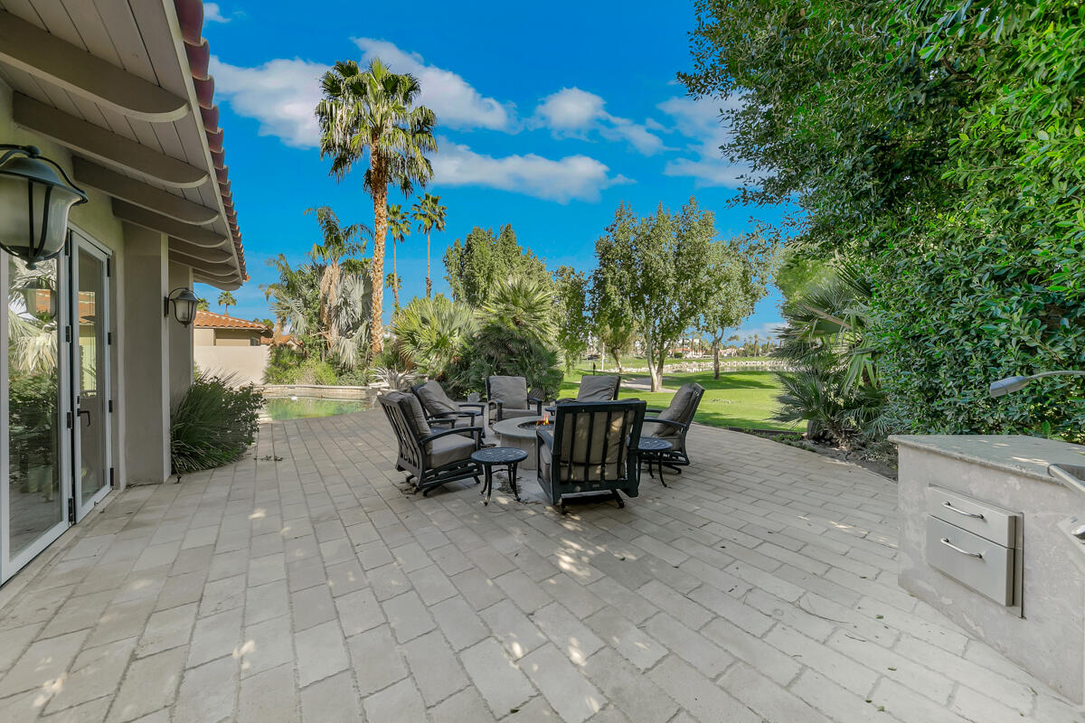 54310 Riviera La Quinta, CA 92253 - Photo 37 of 45 a view of a patio with table and chairs and potted plants