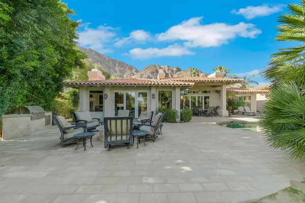 a swimming pool with outdoor seating and yard