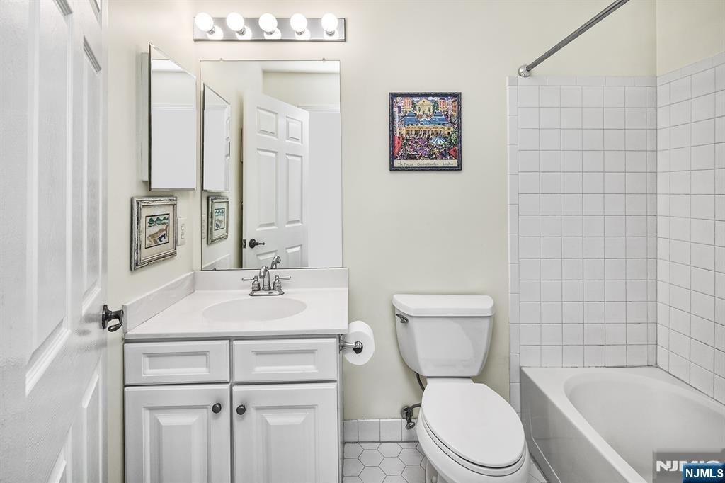 406 Newburgh Court West New York, NJ 07093 - Photo 11 of 31 a bathroom with a sink a toilet and shower