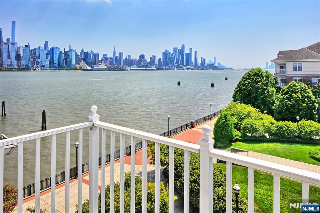 406 Newburgh Court West New York, NJ 07093 - Photo 13 of 31 a front view of a house with outdoor seating and lake view