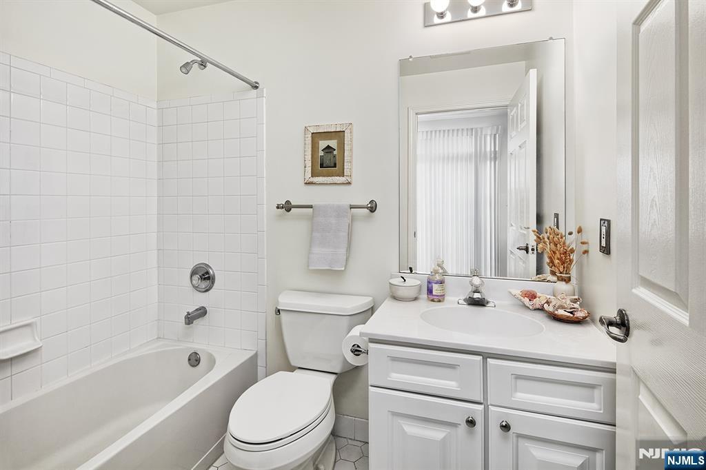 406 Newburgh Court West New York, NJ 07093 - Photo 18 of 31 a bathroom with a sink a toilet and shower