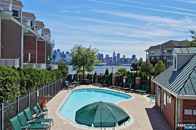 a swimming pool with outdoor seating and yard