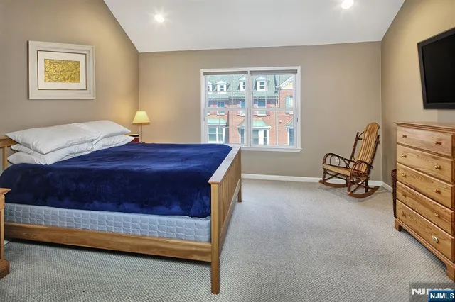 a bed room with a bed and a tv