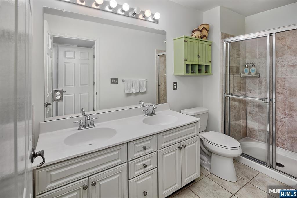 406 Newburgh Court West New York, NJ 07093 - Photo 8 of 31 a bathroom with a sink a toilet and shower