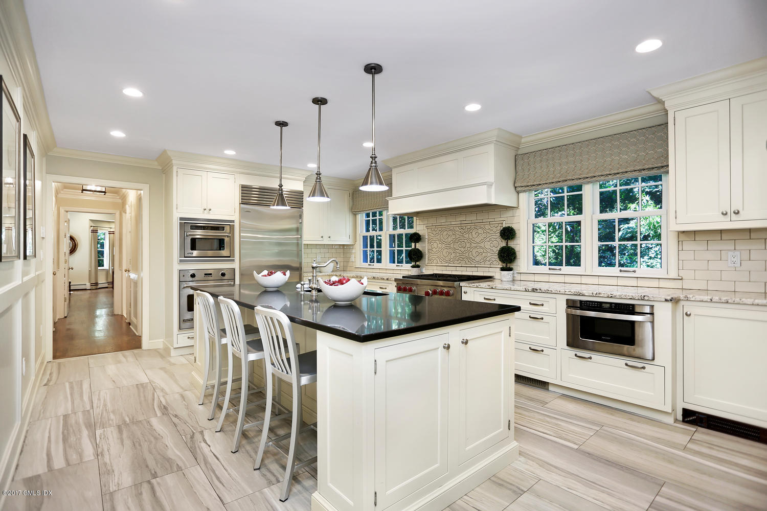 111 Stanwich Road Greenwich, CT 06830 - Photo 11 of 24 a kitchen with stainless steel appliances kitchen island granite countertop a stove top oven a sink a refrigerator and white cabinets with wooden floor