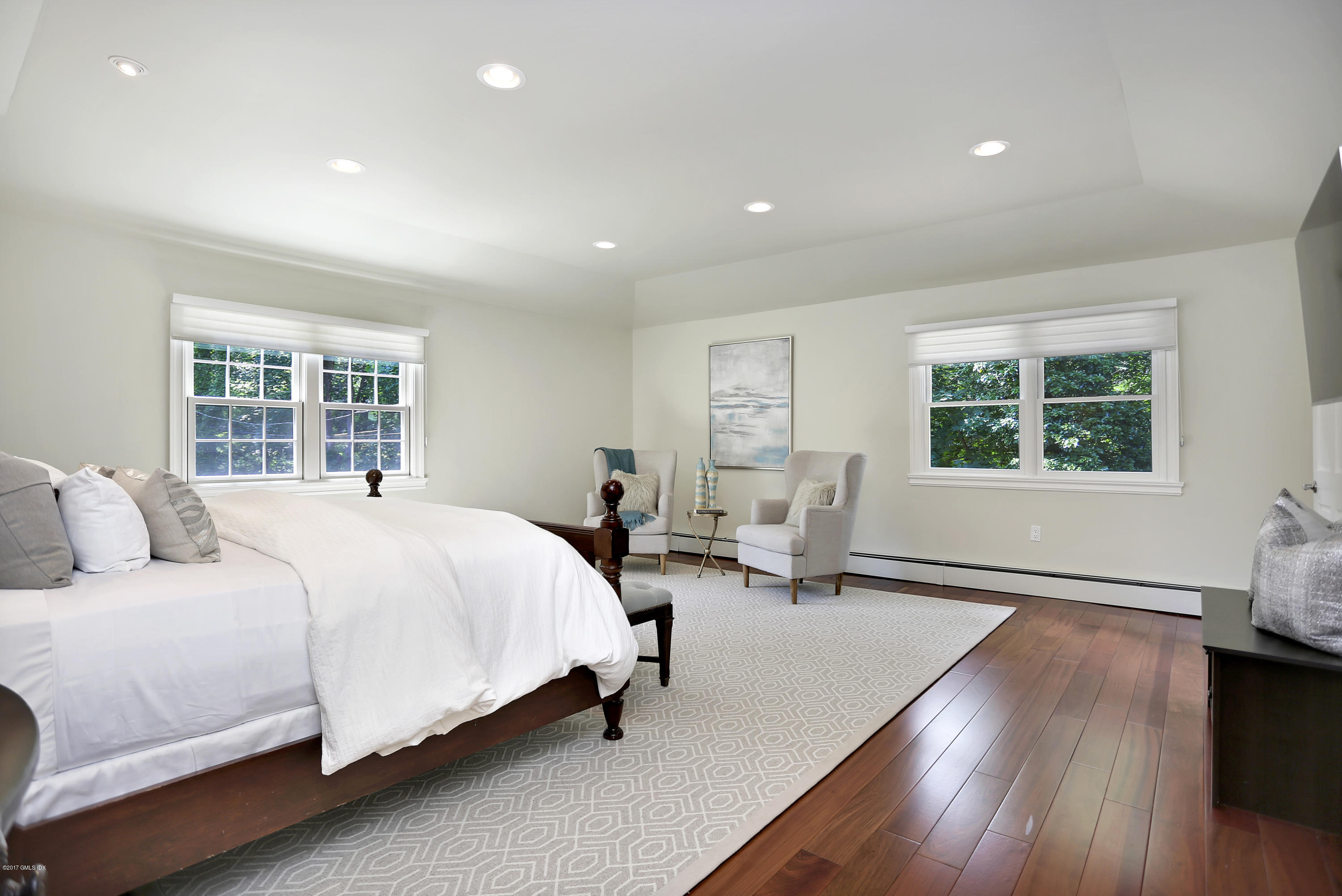 111 Stanwich Road Greenwich, CT 06830 - Photo 14 of 24 a bedroom with a bed and wooden floor
