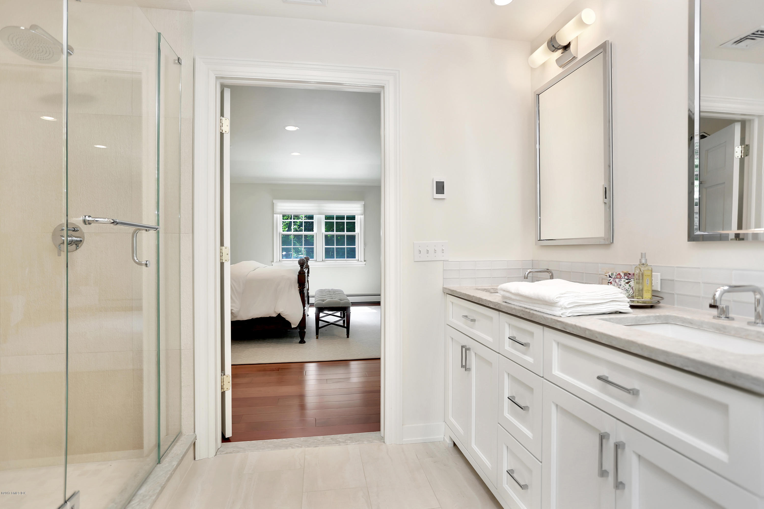 111 Stanwich Road Greenwich, CT 06830 - Photo 15 of 24 a en suite bathroom with a granite countertop sink and a mirror
