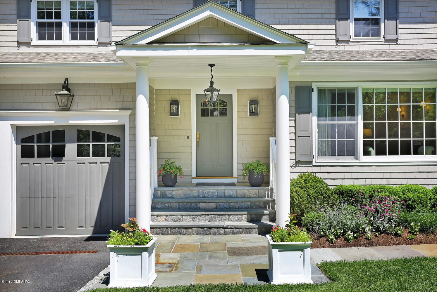 111 Stanwich Road Greenwich, CT 06830 - Photo 2 of 24 a front view of a house with a yard