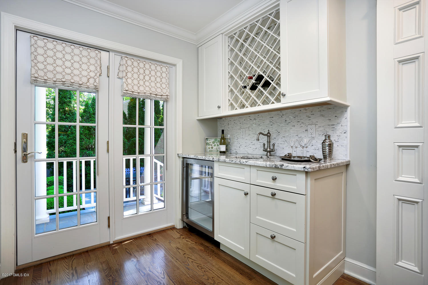 111 Stanwich Road Greenwich, CT 06830 - Photo 10 of 24 a kitchen with granite countertop white cabinets and wooden floor