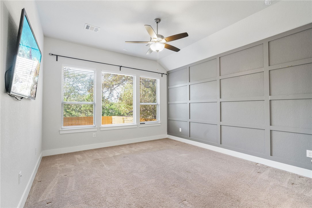 941 Del Raphael Drive Leander, TX 78641 - Photo 14 of 33 Tucked away from the other bedrooms, the primary suite features a custom accent wall that gives the space a distinct, upscale feel