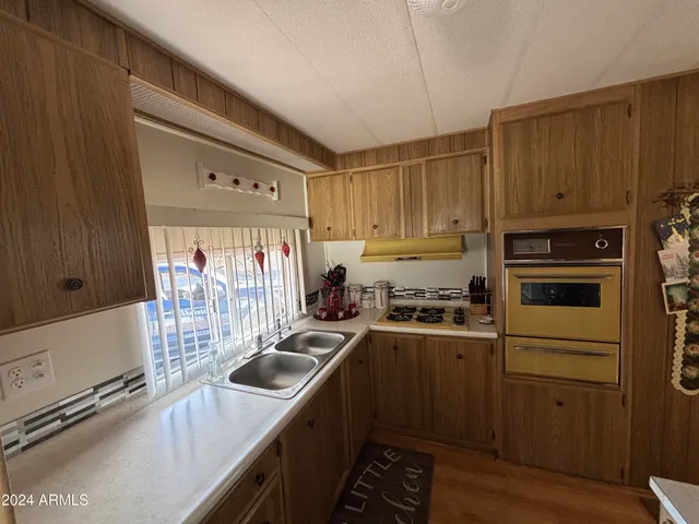 a kitchen with a sink stove and cabinets