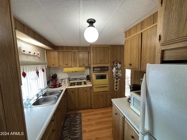 a kitchen with refrigerator a stove and a refrigerator