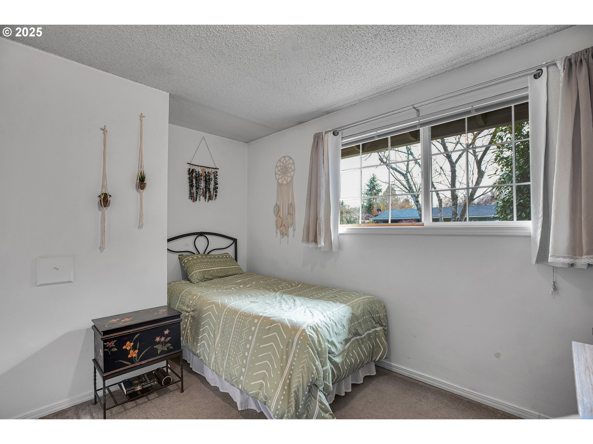 17277 Southwest Sugar Plum Court Beaverton, OR 97007 - Photo 18 of 31 a bedroom with a bed and a tv on the dresser