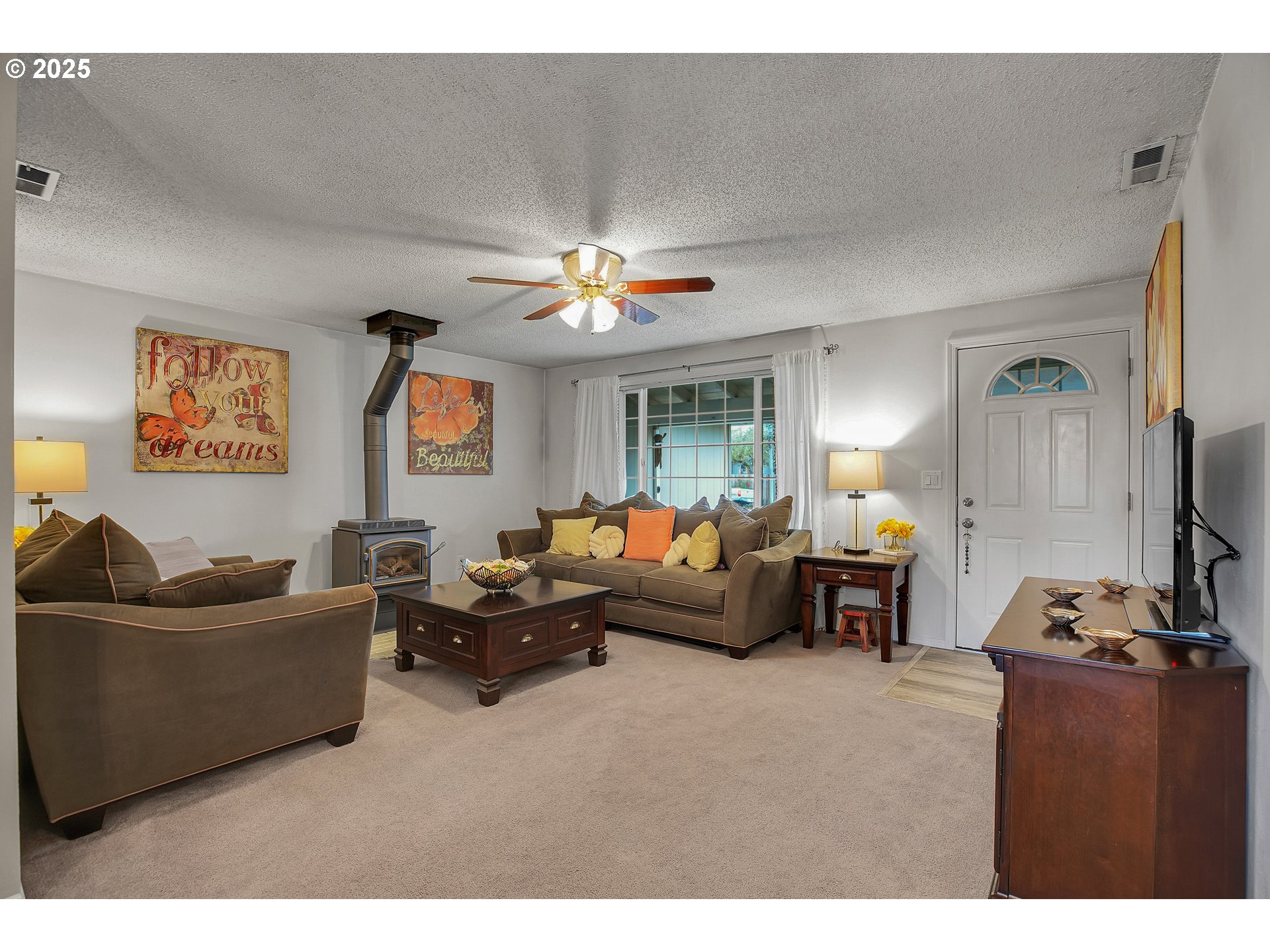 17277 Southwest Sugar Plum Court Beaverton, OR 97007 - Photo 5 of 31 a living room with furniture and a flat screen tv