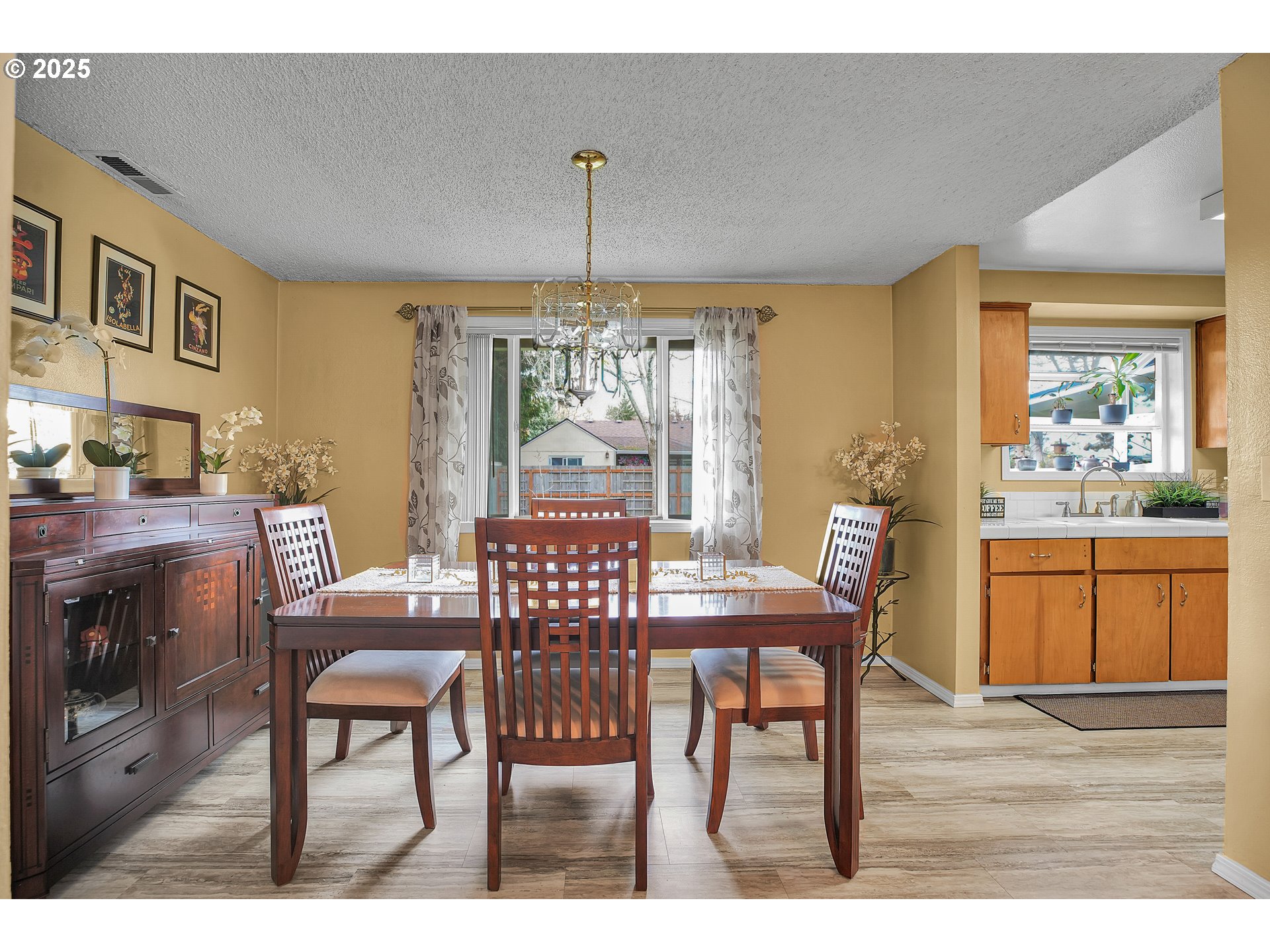 17277 Southwest Sugar Plum Court Beaverton, OR 97007 - Photo 8 of 31 a dining room with furniture a chandelier and wooden floor