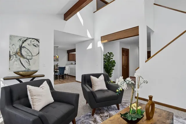 a living room with furniture and a potted plant