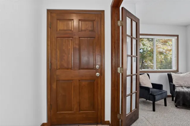 a view of a livingroom with furniture and front door