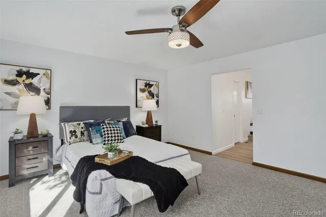 a bedroom with a bed and ceiling fan