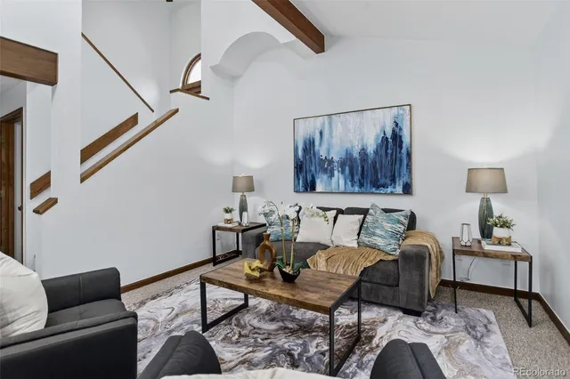 a living room with furniture and a painting