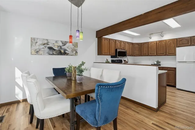 a kitchen with kitchen island a dining table and chairs