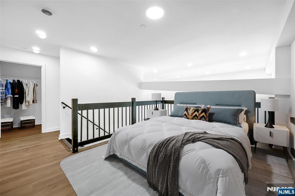 315 Railroad Avenue, Unit 107 East Rutherford, NJ 07073 - Photo 12 of 25 a bed room with a bed and a night stand