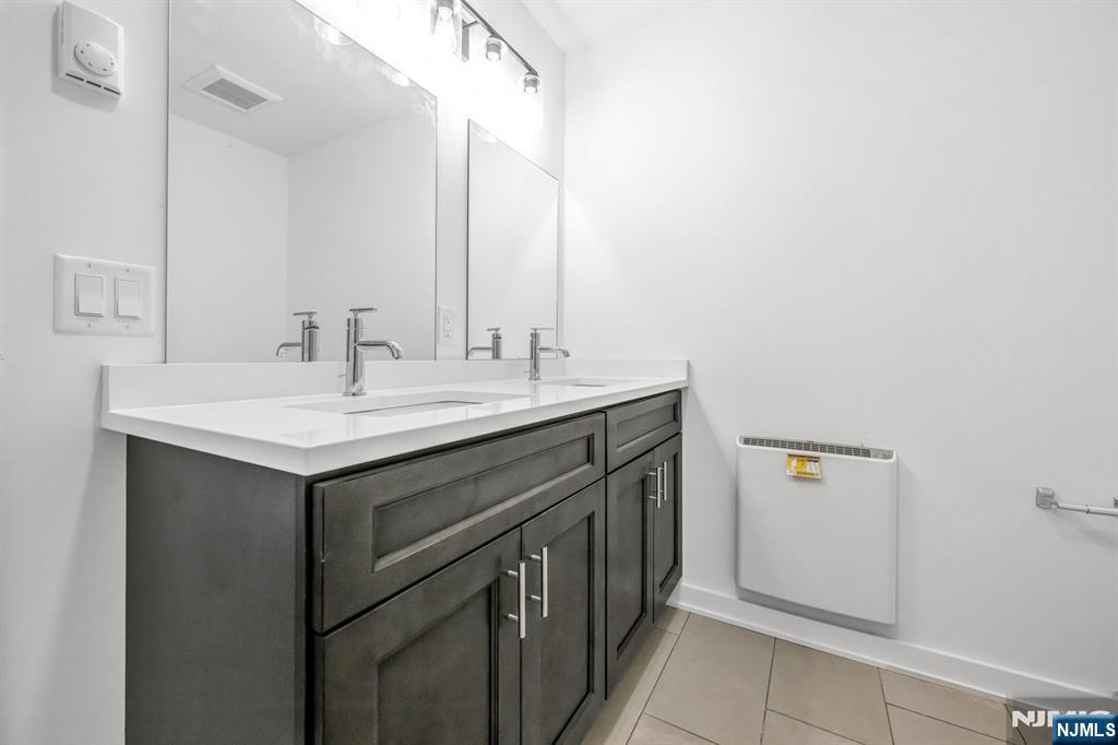 315 Railroad Avenue, Unit 107 East Rutherford, NJ 07073 - Photo 17 of 25 a utility room with a sink and a mirror