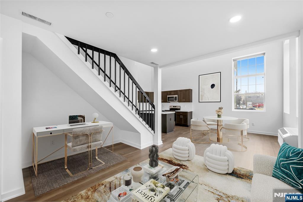 315 Railroad Avenue, Unit 107 East Rutherford, NJ 07073 - Photo 6 of 25 a living room with furniture and wooden floor