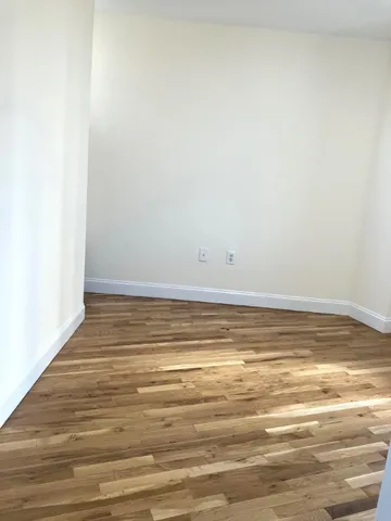 a view of a room with wooden floor